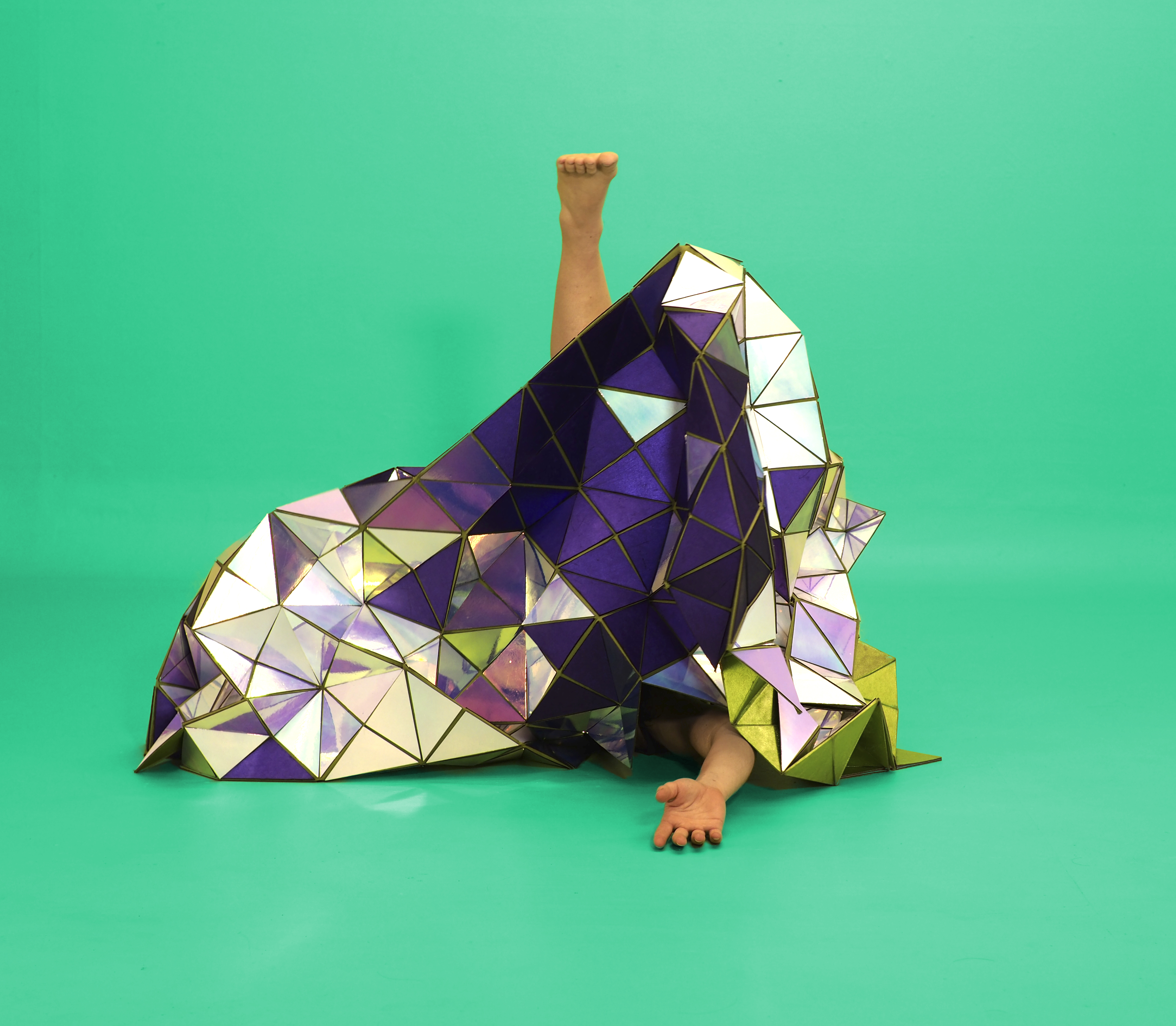 A geodesic tapestry made of mirror triangles and purple fabric, with Lucy Fandel's foot and arm visible.