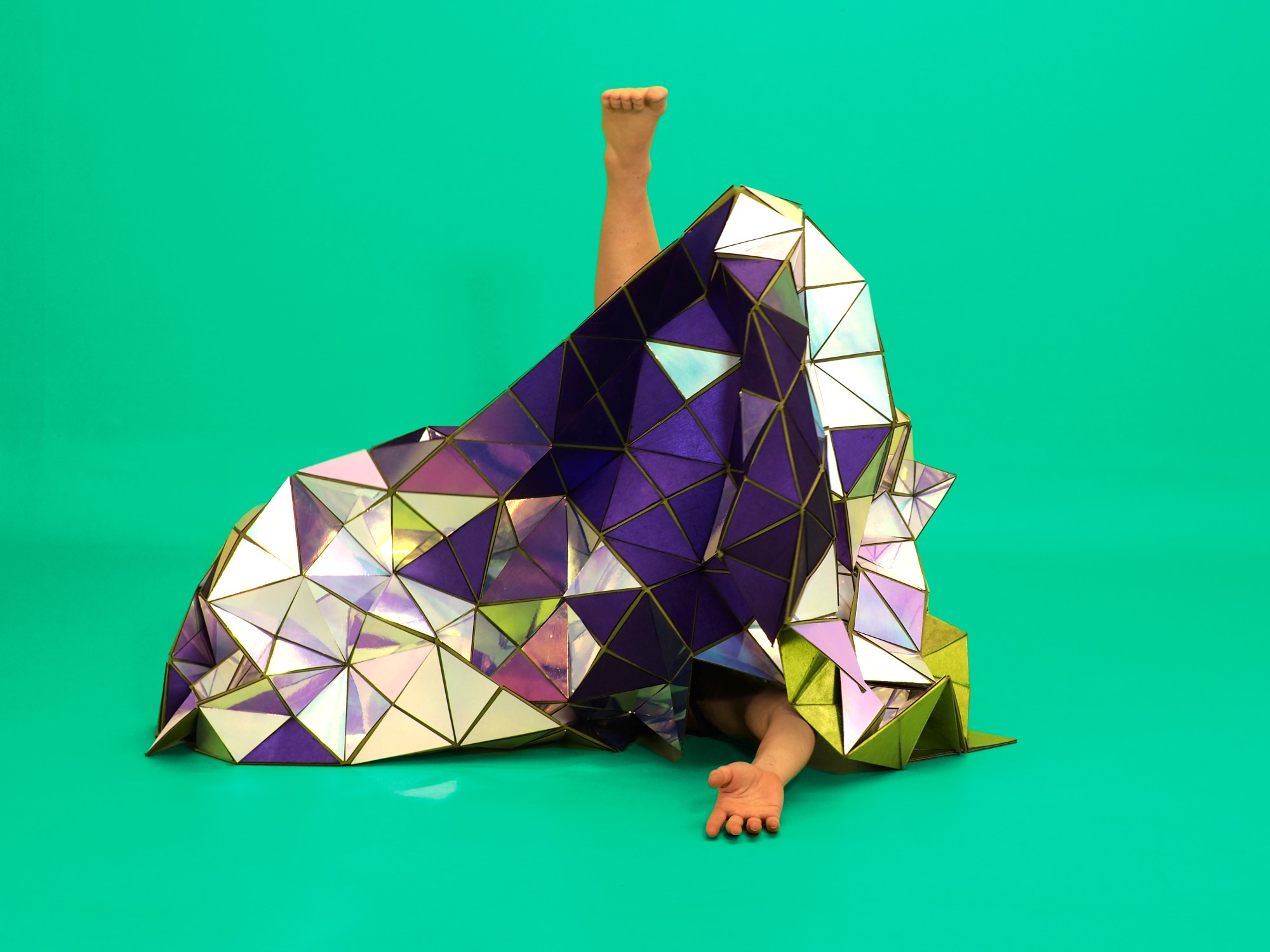A geodesic tapestry made of mirror triangles and purple fabric, with Lucy Fandel's foot and arm visible.
